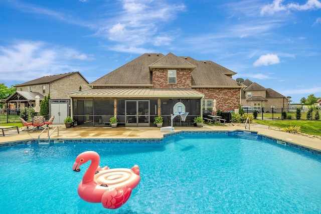 view of swimming pool featuring fence, a fenced in pool, a sunroom, and a patio