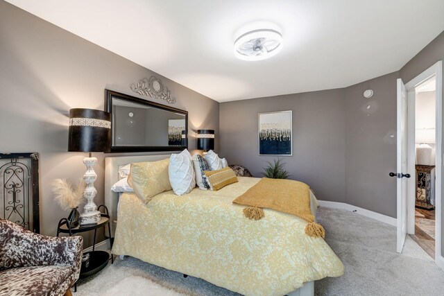 bedroom featuring baseboards and carpet