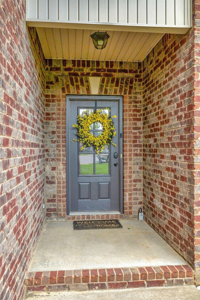 entrance to property with brick siding