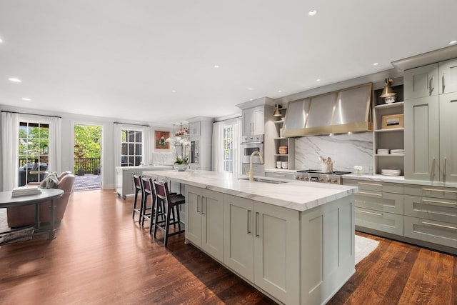 208 Carden Ave, Nashville, TN 37205 - kitchen with a sink, a center island with sink, wall chimney exhaust hood, and a wealth of natural light
