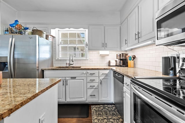 2821 Galesburg Dr, Nashville, TN 37217 - kitchen with a sink, decorative backsplash, white cabinets, and stainless steel appliances