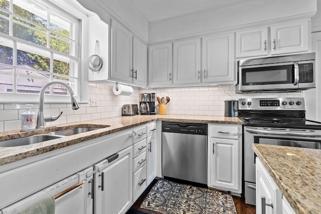 2821 Galesburg Dr, Nashville, TN 37217 - kitchen featuring white cabinets, light stone countertops, a sink, stainless steel appliances, and decorative backsplash