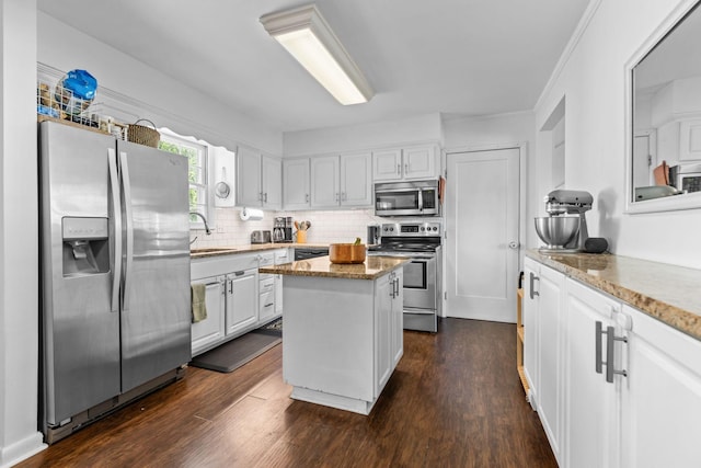 2821 Galesburg Dr, Nashville, TN 37217 - kitchen with white cabinets, light stone countertops, appliances with stainless steel finishes, a sink, and a center island