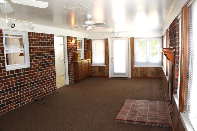 unfurnished sunroom featuring visible vents and plenty of natural light