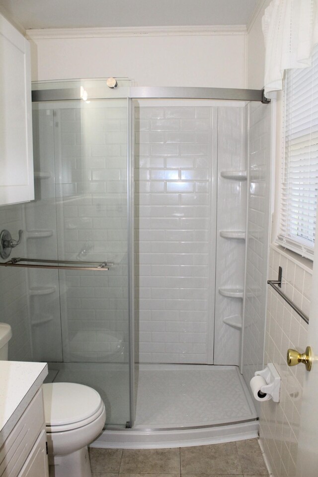 full bath featuring vanity, tile patterned flooring, toilet, and a shower stall