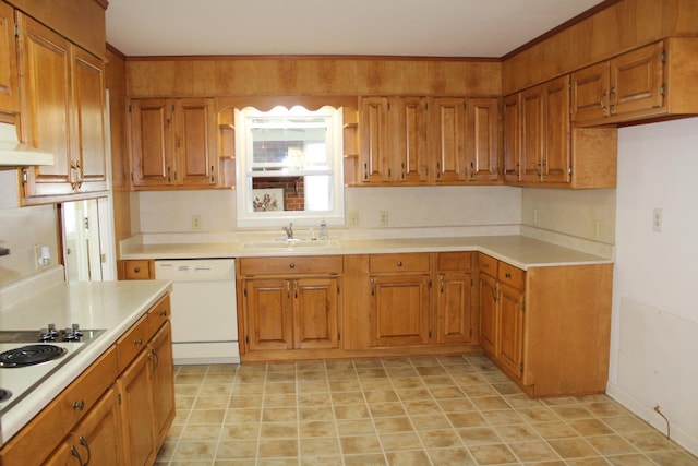 kitchen featuring a sink, brown cabinets, and white appliances