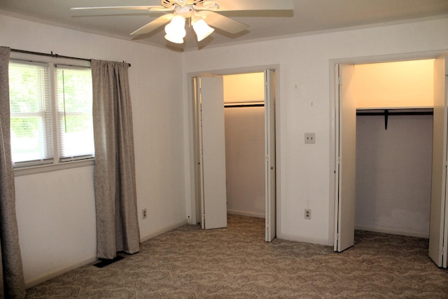 unfurnished bedroom featuring ceiling fan, ornamental molding, and carpet