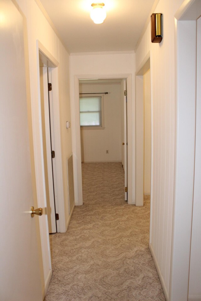 corridor with light colored carpet
