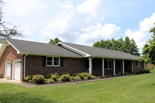 single story home with brick siding, an attached garage, driveway, and a front yard