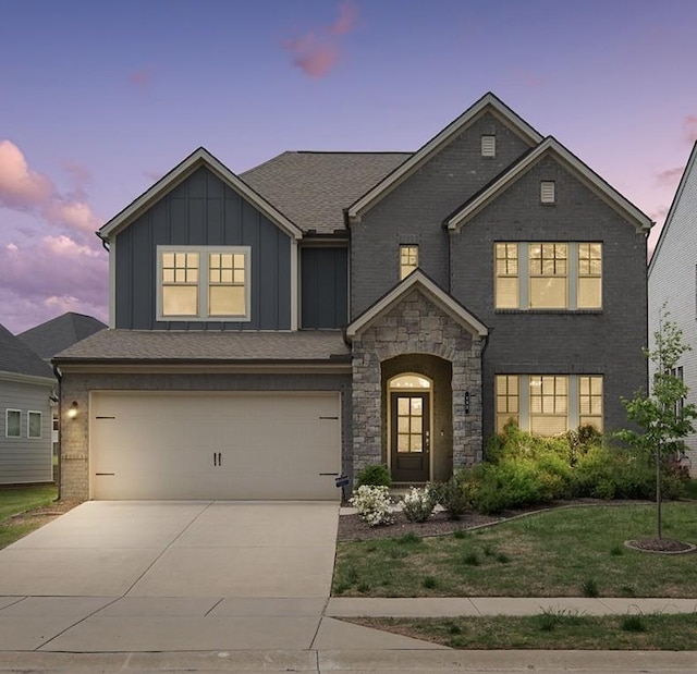 143 Newbury Dr, White House, TN 37188 - view of front facade featuring board and batten siding, a garage, concrete driveway, a yard, and brick siding