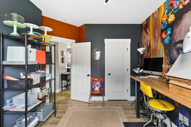 home office with baseboards and wood finished floors