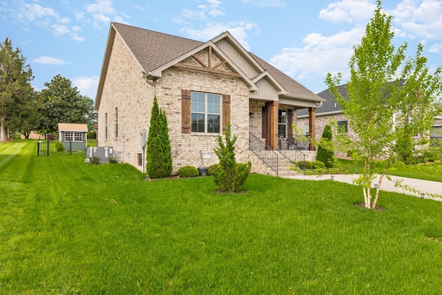 craftsman-style house featuring covered porch, brick siding, and a front yard