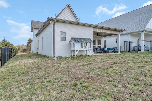 back of property with ceiling fan, a lawn, fence, a patio, and outdoor lounge area