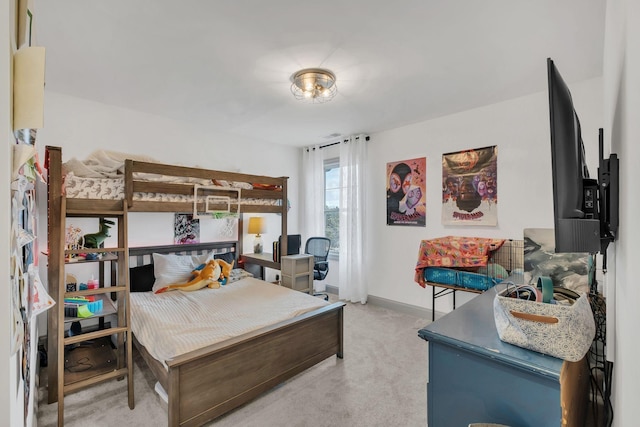 bedroom with baseboards and light carpet