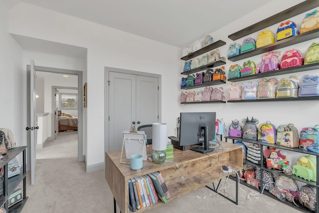 office featuring baseboards and light colored carpet