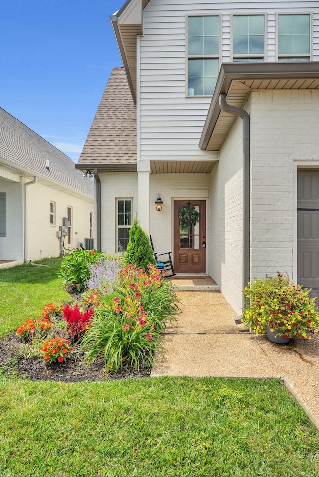 1572 John Galt Dr, Lebanon, TN 37087 - property entrance featuring brick siding, a shingled roof, a yard, and a garage