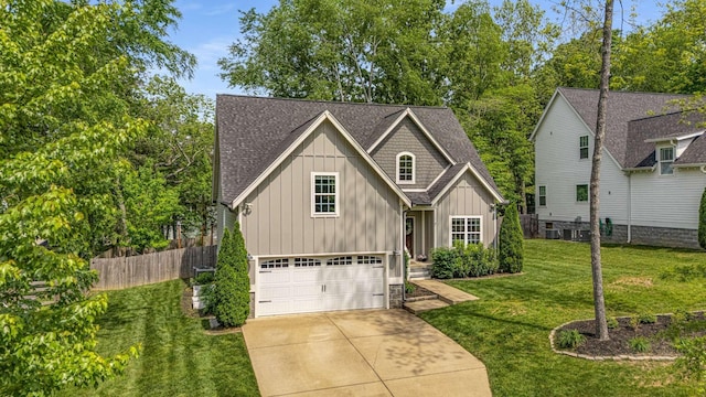 view of front facade with board and batten siding, roof with shingles, fence, a front lawn, and concrete driveway