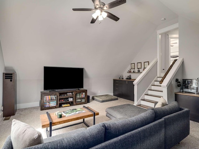 carpeted living area featuring ceiling fan, vaulted ceiling, and baseboards