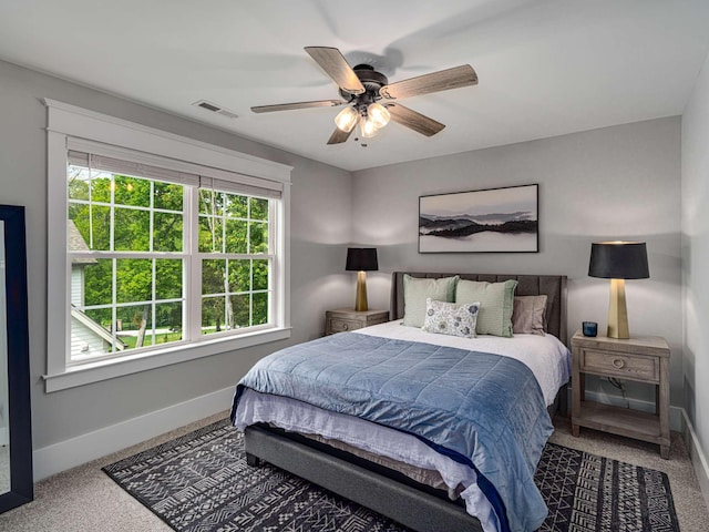 bedroom with a ceiling fan, baseboards, visible vents, and carpet