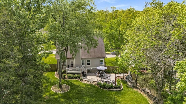rear view of property with a lawn, a fenced backyard, a patio area, and a deck