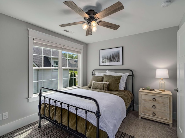 bedroom with baseboards, carpet flooring, a ceiling fan, and visible vents