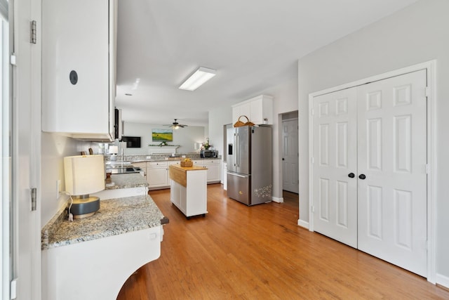 104 Drayton Ct, Franklin, TN 37067 - kitchen featuring light stone countertops, ceiling fan, white cabinetry, light wood finished floors, and appliances with stainless steel finishes