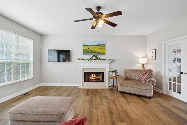 104 Drayton Ct, Franklin, TN 37067 - living room featuring visible vents, wood finished floors, baseboards, ceiling fan, and a fireplace with flush hearth