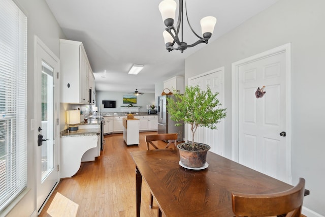 104 Drayton Ct, Franklin, TN 37067 - dining area featuring a healthy amount of sunlight, ceiling fan with notable chandelier, and light wood finished floors
