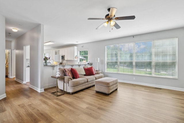 104 Drayton Ct, Franklin, TN 37067 - living room with a ceiling fan, baseboards, visible vents, and light wood-style floors