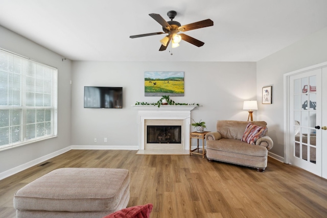 104 Drayton Ct, Franklin, TN 37067 - living area with a ceiling fan, visible vents, a fireplace with flush hearth, wood finished floors, and baseboards