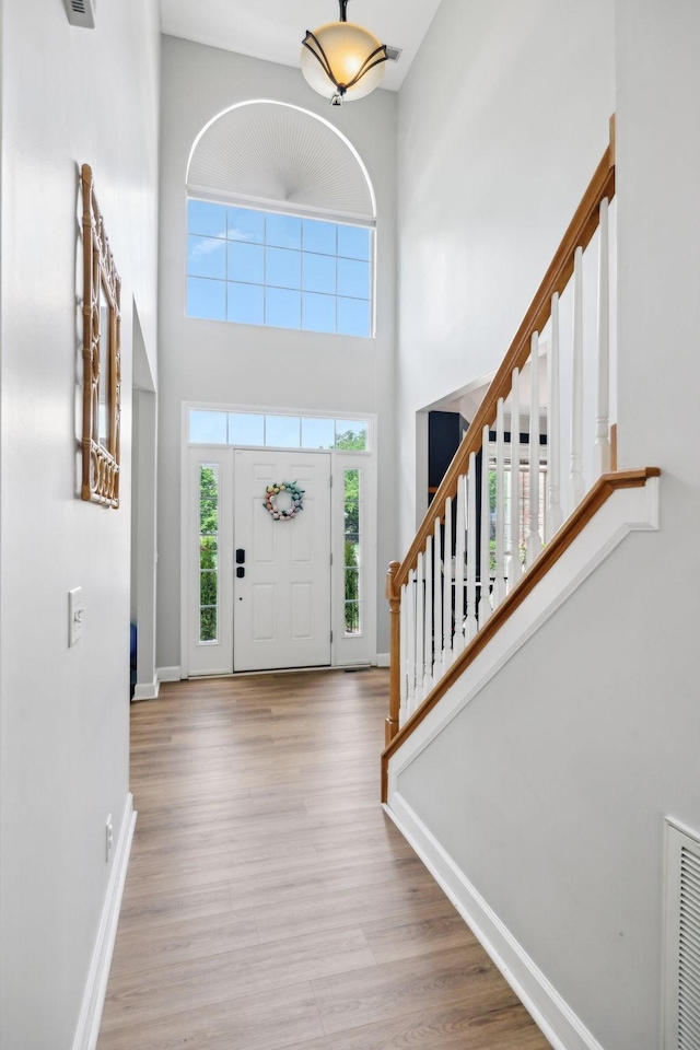 104 Drayton Ct, Franklin, TN 37067 - foyer entrance featuring stairway, plenty of natural light, wood finished floors, and a towering ceiling