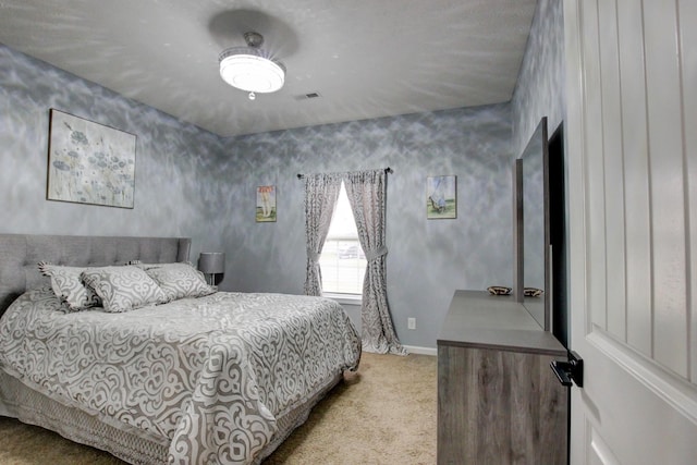 bedroom with carpet floors, baseboards, and visible vents