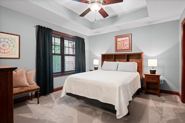 bedroom featuring baseboards, light carpet, and a ceiling fan