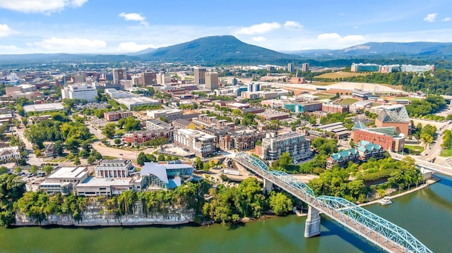 aerial view featuring a water and mountain view and a city view