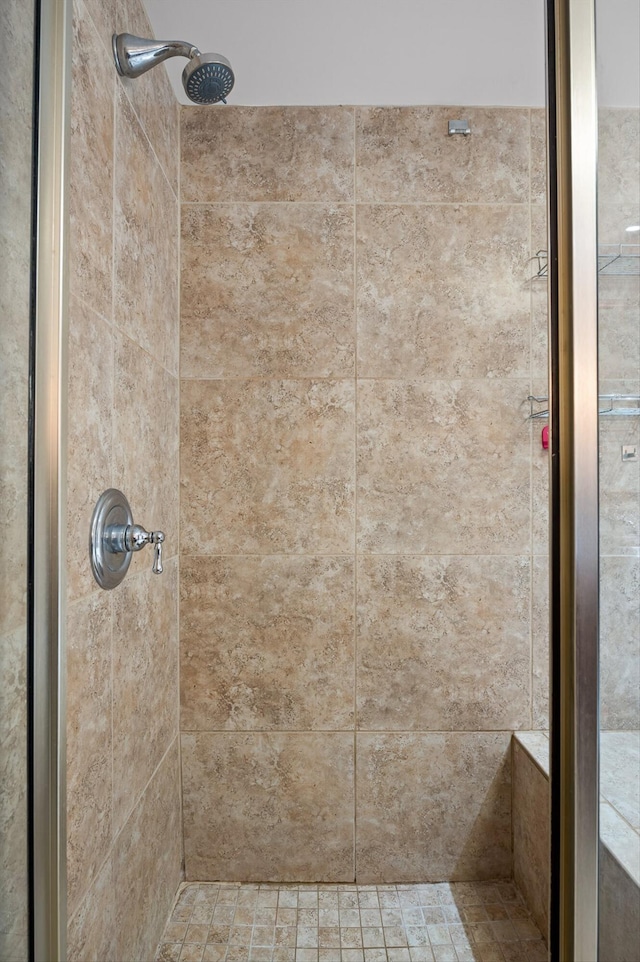 full bath featuring tiled shower