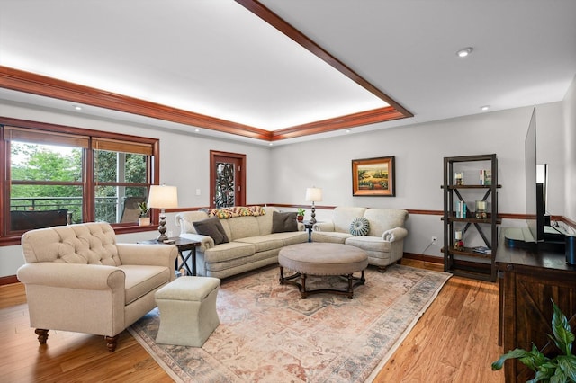 living room featuring recessed lighting, baseboards, a tray ceiling, and hardwood / wood-style flooring