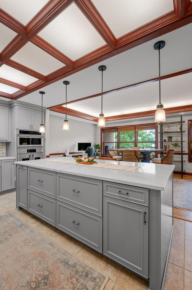 kitchen with light countertops, stainless steel double oven, and gray cabinetry