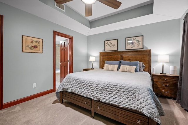 bedroom with a ceiling fan, visible vents, baseboards, carpet, and ensuite bath