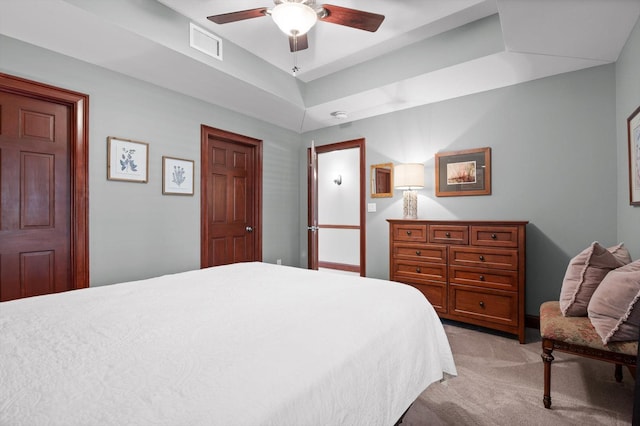 bedroom with visible vents, ceiling fan, and light colored carpet