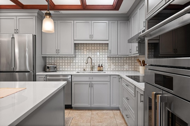 kitchen with light countertops, a sink, gray cabinets, and stainless steel appliances