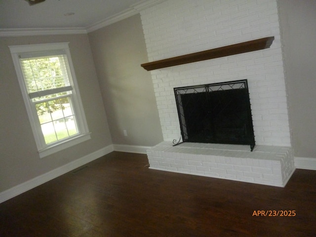 1314 Jewell Dr, Columbia, TN 38401 - unfurnished living room featuring crown molding, baseboards, dark wood-type flooring, and a fireplace