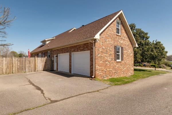 1314 Jewell Dr, Columbia, TN 38401 - view of home's exterior with fence, a garage, aphalt driveway, and brick siding
