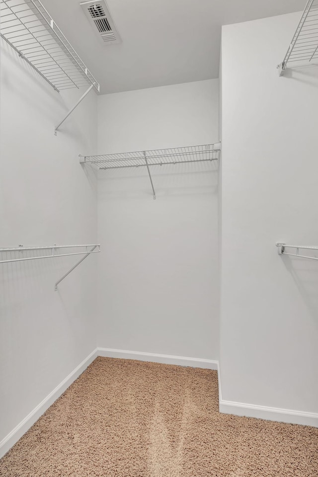 walk in closet with carpet floors and visible vents