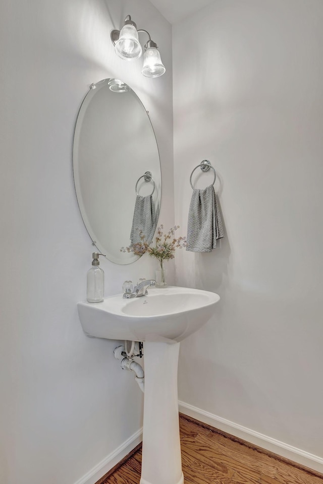 bathroom featuring baseboards and wood finished floors
