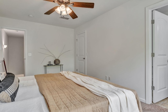 bedroom featuring baseboards, a ceiling fan, light colored carpet, and visible vents