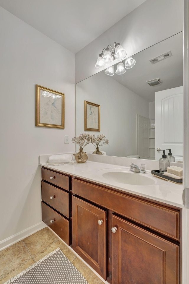 bathroom with visible vents, a sink, tile patterned floors, and double vanity