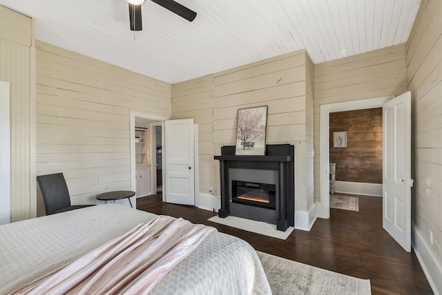 1614 Wade Rd, Lewisburg, TN 37091 - bedroom with wood walls, dark wood finished floors, a fireplace with flush hearth, a ceiling fan, and wooden ceiling