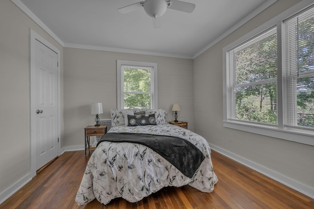 bedroom featuring crown molding, baseboards, a ceiling fan, and dark wood-style floors