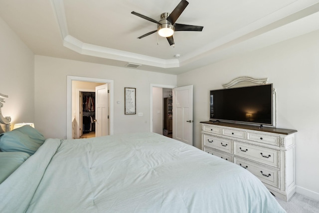 907 Caywood Rd, Smyrna, TN 37167 - bedroom featuring light colored carpet, visible vents, a ceiling fan, a tray ceiling, and a walk in closet