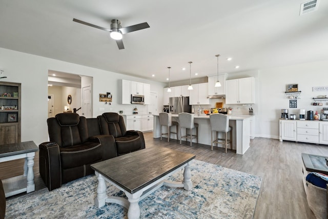 907 Caywood Rd, Smyrna, TN 37167 - living area with wood finished floors, visible vents, baseboards, ceiling fan, and recessed lighting